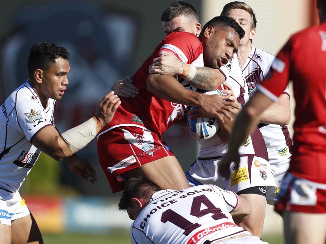 Mosese Pangai of Redcliffe Dolphins is tackled by Jeff Lynch and Dylan Phythian of Burleigh Bears in the Intrust Super Cup rugby league match played at the Dolphins stadium, Redcliffe. PHOTO: AAP/Regi Varghese