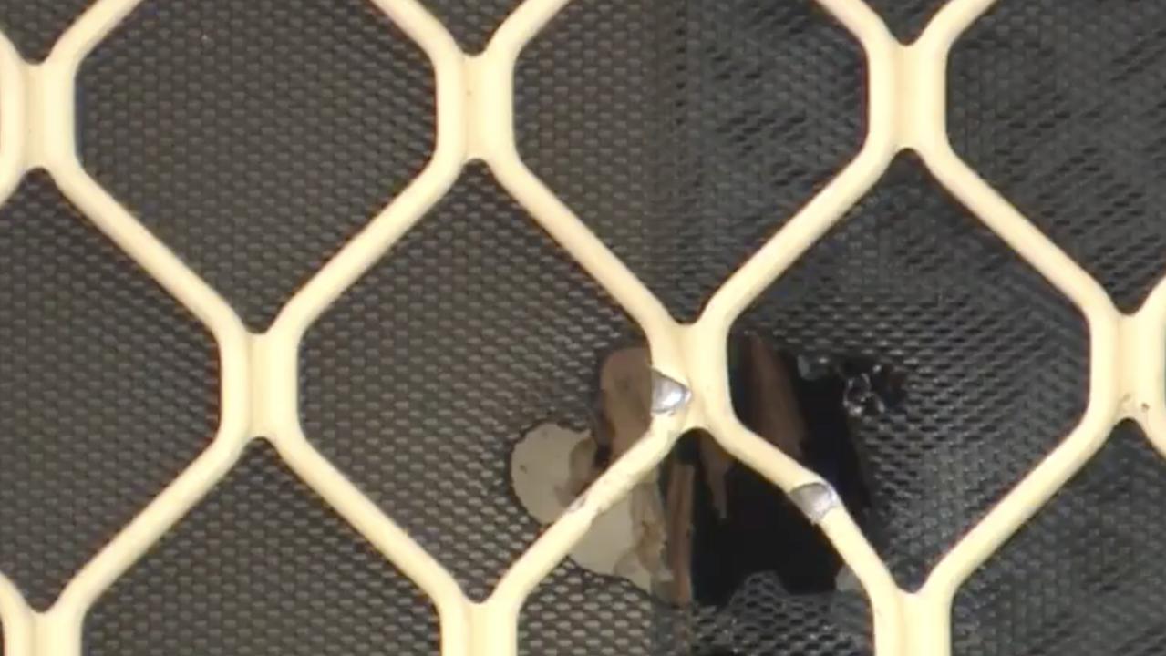 Bullet holes were left through the screen door and garage roller door. Picture: Russell Millard Photography