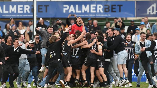 Port District players and fans celebrate their 2022 grand final win over Prince Alfred OC. Picture: Tricia Watkinson