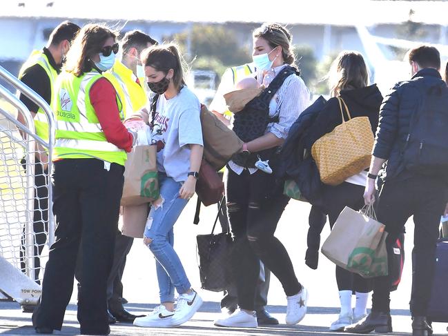 Partners and children of Sydney Swans and GWS Giants AFL players leaving Brisbane airport after completing quarantine in Brisbane heading to Melbourne., - Fiona Falkiner (M) , Thursday August 5, 2021. Picture,John Gass