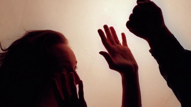 Domestic violence silhouette generic image – fist raised against woman./Violence