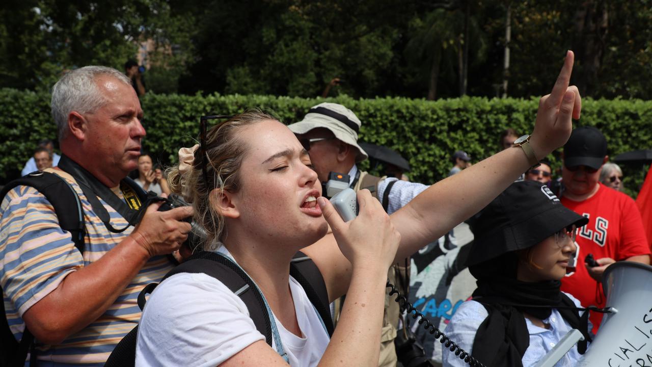 A protester yells into the megaphone. Picture: NCA NewsWire / Nicholas Eagar