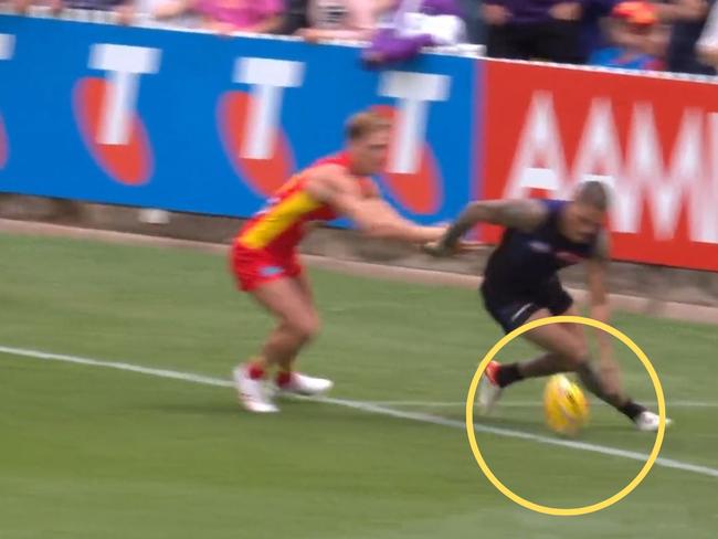 Michael Walters chases a ball out of bounds during Gather Round 2023 against the Gold Coast Suns.