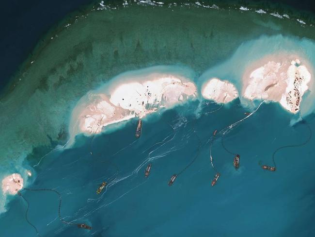 Photos by satellite-imagery provider DigitalGlobe shows what is believed to be Chinese vessels dredging sand at Mischief Reef in the Spratly Islands in the South China Sea. PHOTO: AGENCE FRANCE-PRESSE/GETTY IMAGES