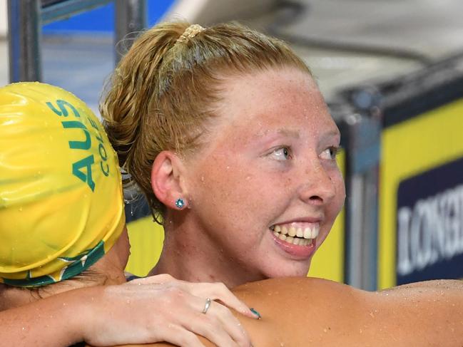 Lakeisha Patterson of Australia (right) hugs Ellie Cole of of Australia after winning the Women's S9 100m Freestyle Final on day four of swimming competition at the XXI Commonwealth Games at Gold Coast Aquatic Centre on the Gold Coast, Australia, Sunday, April 8, 2018. (AAP Image/Dave Hunt) NO ARCHIVING, EDITORIAL USE ONLY