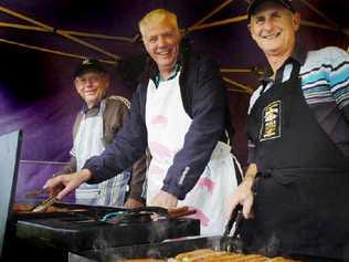 Lions Club of Lennox Head members Don Hurley (left), Dan Anderson and Bob Burnell cook sausages for local residents at a benefit barbecue and auction for the Tornado Appeal. Picture: jerad williams