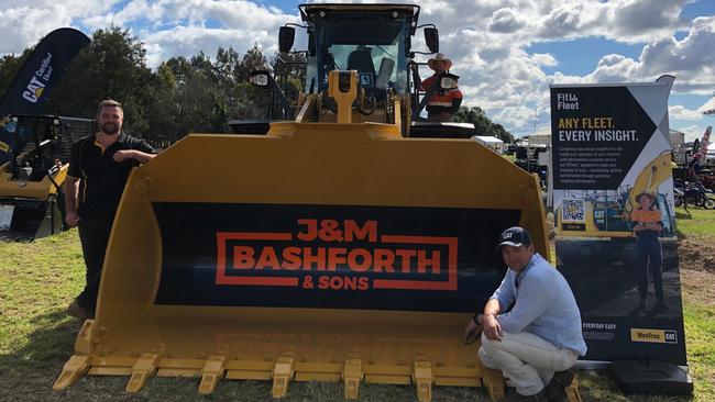 Setting you back a cool $5000,000, this CAT Front End Loader is worth every penny, according to (left) Morgan Rose, Westrac Cat sales Northern Rivers, Tamworth / Moree sales Tim Moore and wearing the best hat at Primex Casino, Jim Hewitt, the CAT product support representative. Photo: Alison Paterson