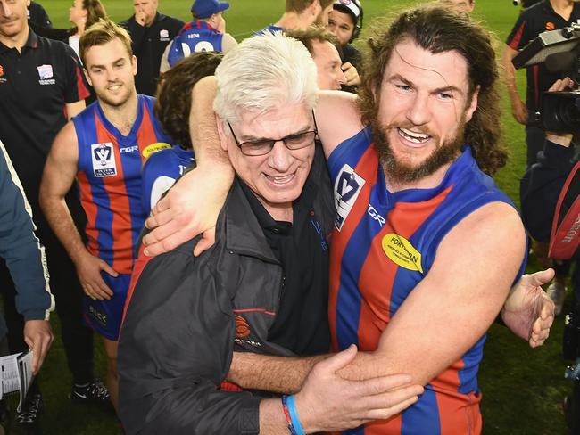 Gary Ayres and Toby Pinwill embrace after the 2017 grand final victory over Richmond at Marvel Stadium.