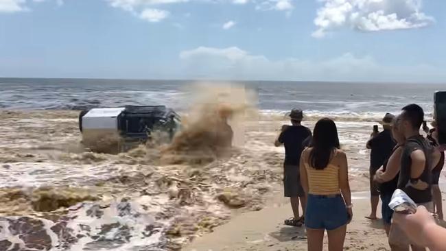 A 4WD is seen crossing a new channel that formed after a lagoon broke its banks on Bribie Island. Picture: Prellin Chetty