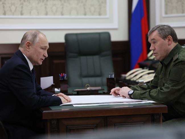 Vladimir Putin chats with Army chief of staff Valery Gerasimov at military headquarters in Rostov-on-Don. Picture: AFP