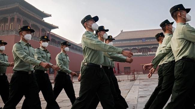 People’s Liberation Army soldiers march in May outside the Forbidden City at the opening ceremony to the Chinese People’s Po`litical Consultative Conference in Beijing. Picture: AFP