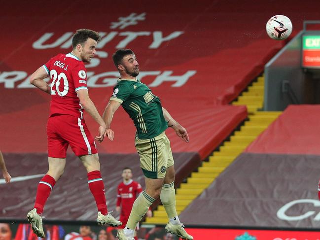 Liverpool's Portuguese striker Diogo Jota (2L) heads the ball to score their second goal during the English Premier League football match between Liverpool and Sheffield United at Anfield in Liverpool, north west England on October 24, 2020. (Photo by Peter Byrne / POOL / AFP) / RESTRICTED TO EDITORIAL USE. No use with unauthorized audio, video, data, fixture lists, club/league logos or 'live' services. Online in-match use limited to 120 images. An additional 40 images may be used in extra time. No video emulation. Social media in-match use limited to 120 images. An additional 40 images may be used in extra time. No use in betting publications, games or single club/league/player publications. /