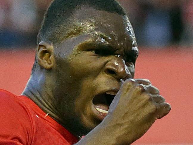 Liverpool's Christian Benteke right, celebrates with team-mate Dejan Lovren after he scores the first goal for his side during their English Premier League soccer match against Bournemouth at Anfield in Liverpool, England, Monday Aug. 17, 2015. (AP Photo/Clint Hughes)