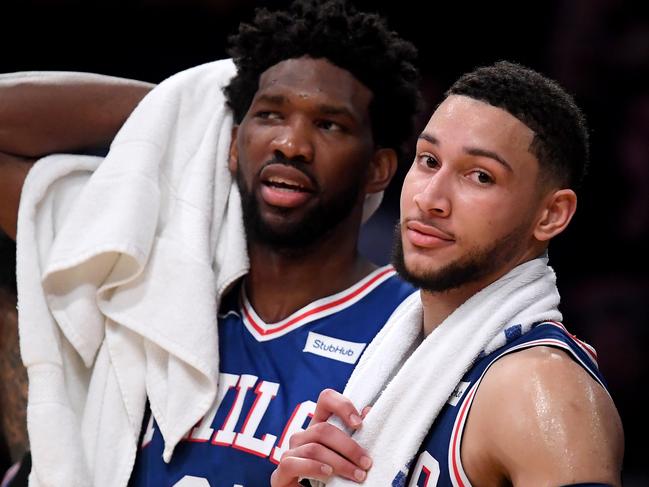 LOS ANGELES, CALIFORNIA - JANUARY 29: Ben Simmons #25 and Joel Embiid #21 of the Philadelphia 76ers watch play in the final minutes during a 121-105 win over the Los Angeles Lakers at Staples Center on January 29, 2019 in Los Angeles, California. NOTE TO USER: User expressly acknowledges and agrees that, by downloading and or using this photograph, User is consenting to the terms and conditions of the Getty Images License Agreement.   Harry How/Getty Images/AFP == FOR NEWSPAPERS, INTERNET, TELCOS & TELEVISION USE ONLY ==