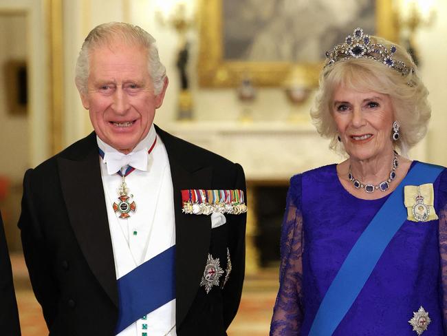 (FILES) In this file photo taken on November 22, 2022 Britain's King Charles III and Britain's Camilla, Queen Consort wearing a brooch depicting an image of the late Queen Elizabeth II, pose for a photograph during a State Banquet at Buckingham Palace in London on, at the start of the President's of South Africa's two-day state visit. - Buckingham Palace announced on March 3, 2023, that King Charles III's first state visit to France will start on March 26. It will take place shortly after a first visit to France by British Prime Minister Rishi Sunak on March 10 for a bilateral summit. (Photo by Chris Jackson / POOL / AFP)