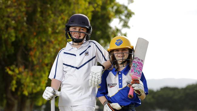 Riley, 11, and Emily, 8, Parsons posing at Helensvale in their cricket gear. Picture: AAP/Josh Woning