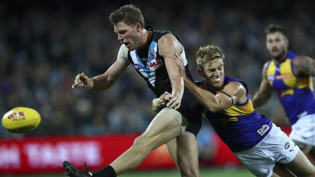 Port Adelaide’s Brad Ebert gets his kick away from West Coast’s Brad Sheppard. Picture: SARAH REED