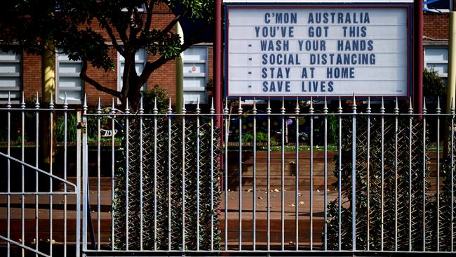 A sign with tips to fight the coronavirus at a school at Observatory Hill in Sydney.