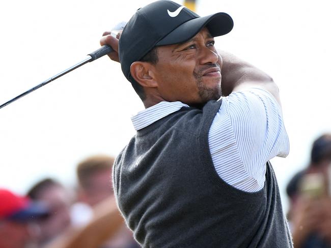 (FILES) In this file photo US golfer Tiger Woods watches his iron shot from the 16th tee during his third round on day 3 of The 147th Open golf Championship at Carnoustie, Scotland on July 21, 2018. - Tiger Woods was hospitalized following a bad single-car accident in Los Angeles County on the morning of February 23, 2021, with officials requiring the jaws of life to free him from the vehicle. "On February 23, 2021, at approximately 7:12 am,  LASD responded to a single vehicle roll-over traffic collision on the border of Rolling Hills Estates and Rancho Palos Verdes," officials say. (Photo by Andy BUCHANAN / AFP)