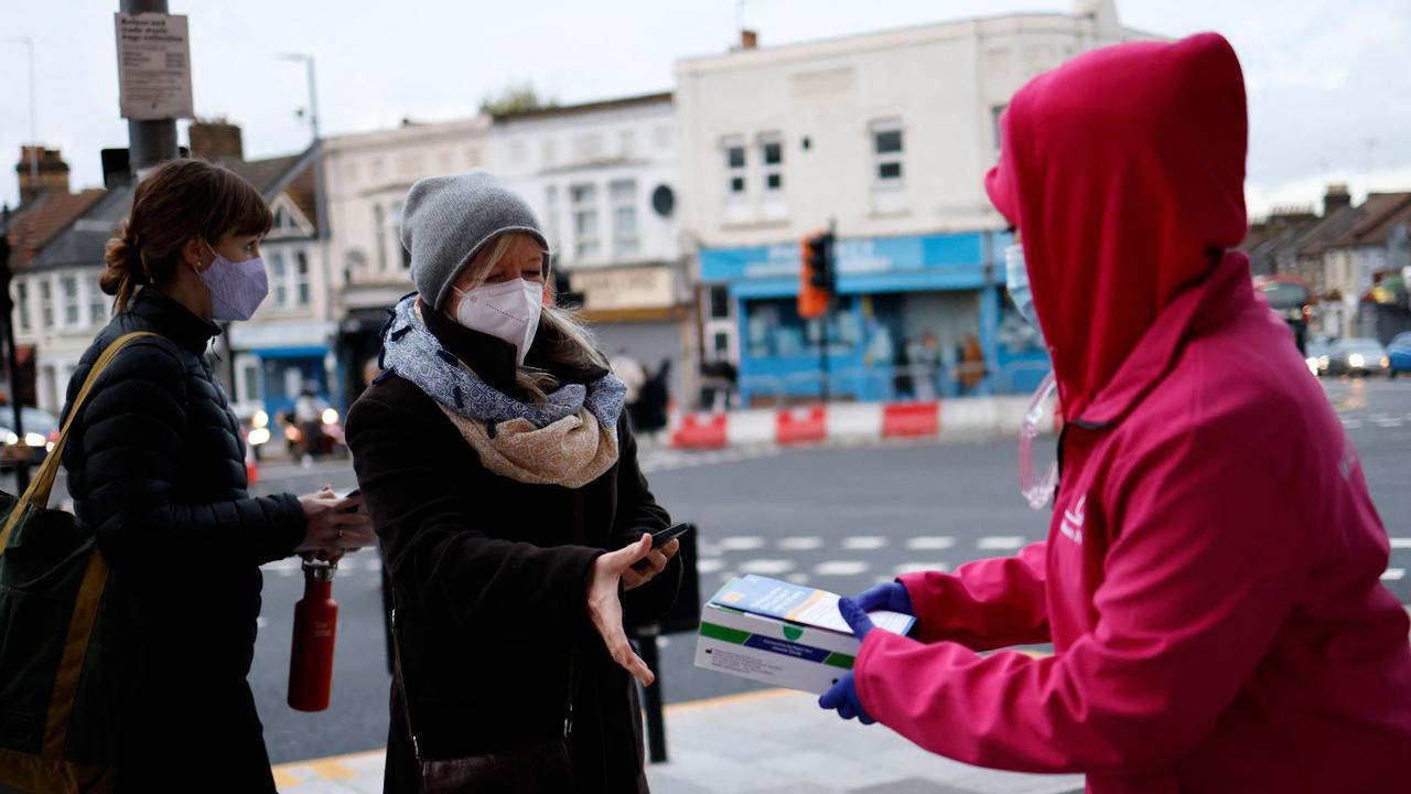 Volunteers hand out boxes of Covid-19 rapid antigen Lateral Flow Tests (LFT), in north east London on January 3, 2022. Picture: Tolga Akmen / AFP.