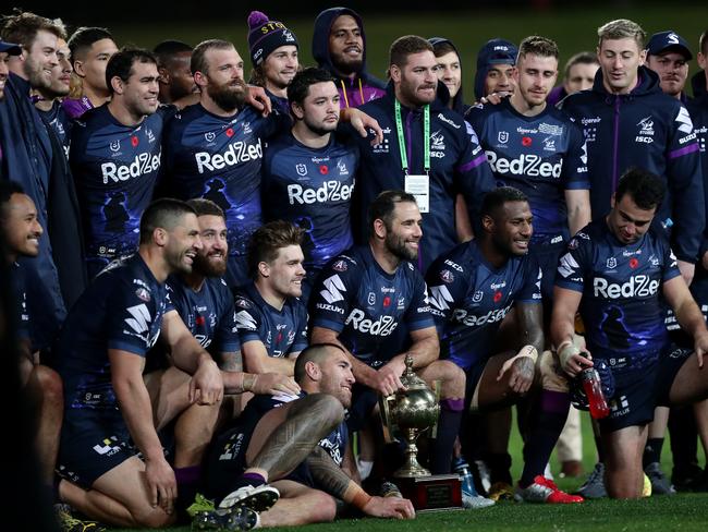 SYDNEY, AUSTRALIA - JUNE 26:  Cameron Smith of the Storm poses with team mates with the Michael Moore Trophy after the round seven NRL match between the Melbourne Storm and the New Zealand Warriors at Netstrata Jubilee Stadium on June 26, 2020 in Sydney, Australia. (Photo by Mark Metcalfe/Getty Images)