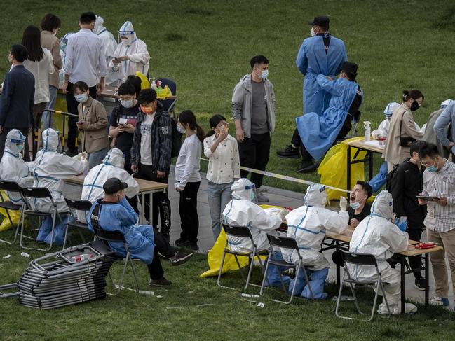 Health workers wear protective suits as employees from local hi-tech companies are given nucleic acid tests in Beijing, China. Picture: Getty Images