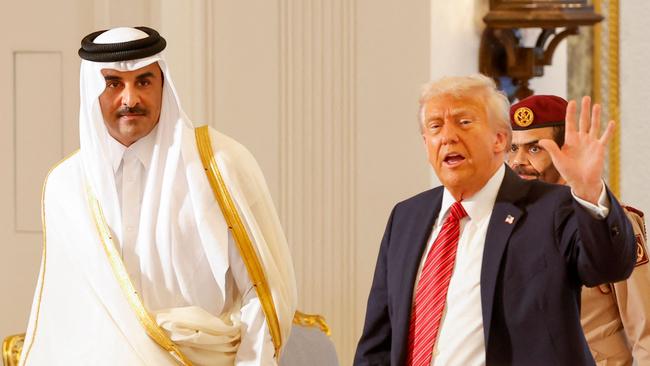 Qatar's Emir Sheikh Tamim bin Hamad al-Thani and US President Donald Trump leave after a signing ceremony at the Royal Palace in Doha on Wednesday. Picture: AFP