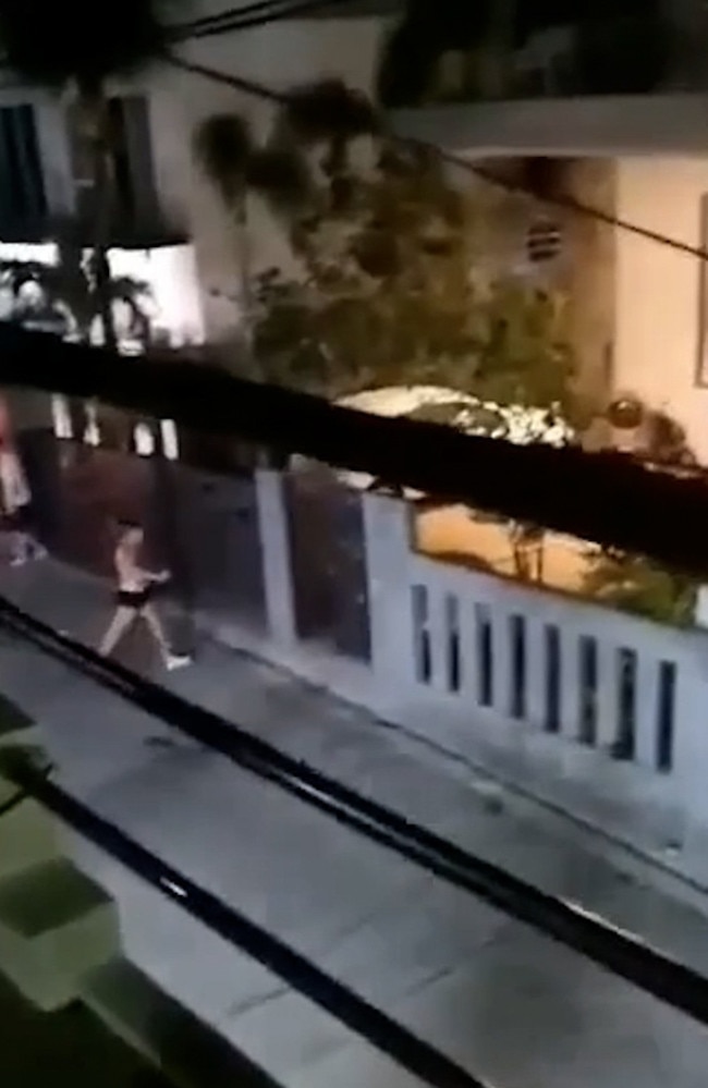 Footage of the brawl shows a naked sex workers running into the road as the two groups hurled glasses and garden pots at each other over the garden wall. Picture: Viral Press