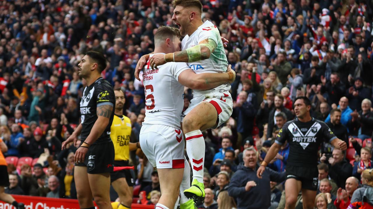 Tommy Makinson celebrates one of his three tries against the Kiwis in the second Test.