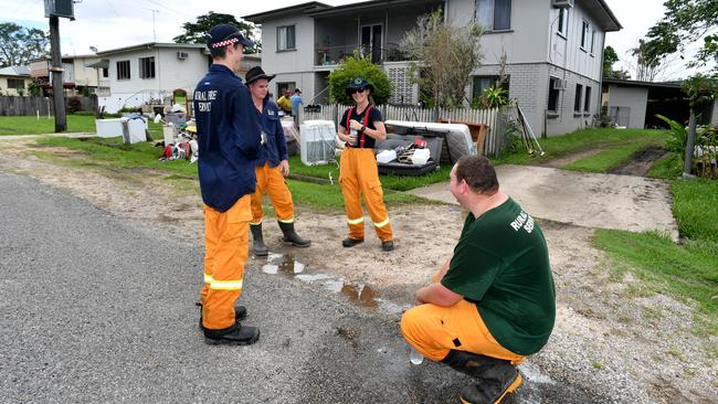 Rural firefighters from Ruperswood and Black River take a break after cleaning out a block of units on Venables St in Ingham. Picture: Evan Morgan