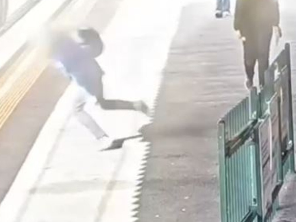 A passenger trips on the platform at Caulfield station.