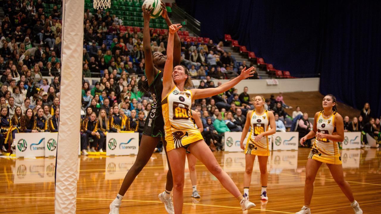 Cavaliers goal attack Esther Kidmas clashed in the air with Northern Hawks goal defence Tessa Coote in the grand final clash at Launceston's Silverdome. Picture: PATRICK GEE/SUPPLIED