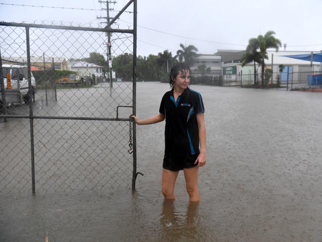 Erin Hollaway locks up a gate in Camgulia Street, Mt Louisa. Picture: Evan Morgan