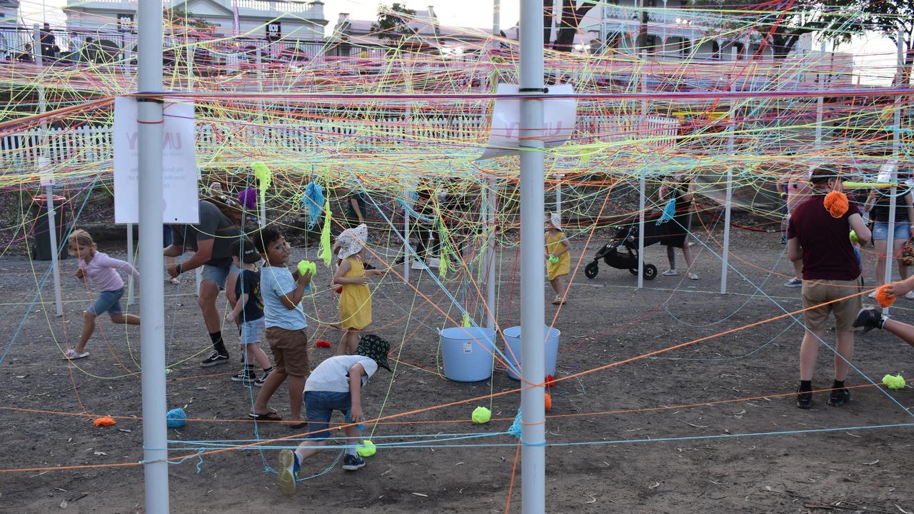 Kids enjoying spreading yarn in the Unity art circle.