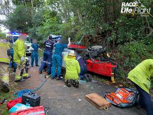 A man was pinned underneath his rolled tractor for more than an hour today and was flown to hospital by the RACQ's LifeFlight Rescue. Photo: LifeFlight media. 