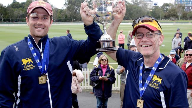 Peter Dickson and coach Michael O'Sullivan raise the 2015/16 silverware. Picture: Hamish Blair