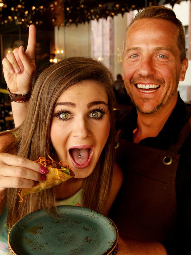 Rebecca Boggiano tries the spicy taco with restaurant co-founder Octavio Gomez-Harro cheering her on.