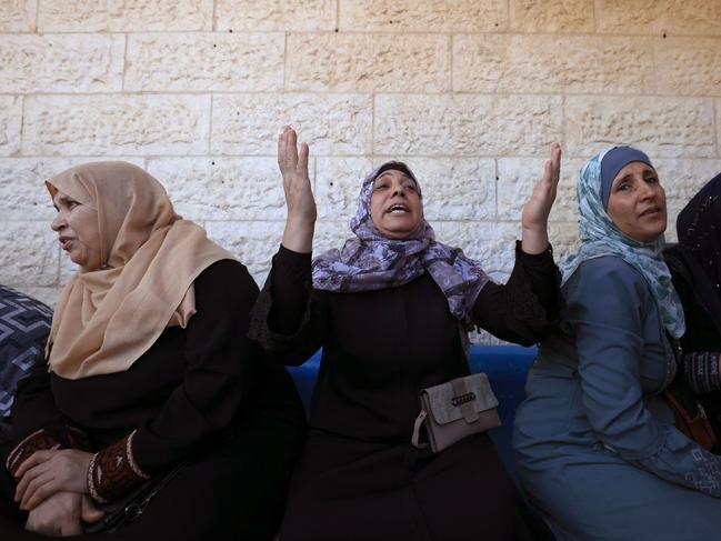 Family members grieve during the funeral of Palestinians displaced from northern Gaza and killed during an Israeli military attack in the town of Deir Al-Balah, in the central Gaza Strip, on October 15. Picture: AFP