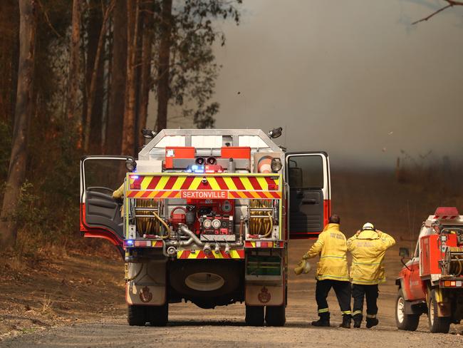 Firefighters battle bushfires in Busbys Flat, northern NSW, Wednesday, October 9, 2019. (AAP Image/Jason O'Brien)