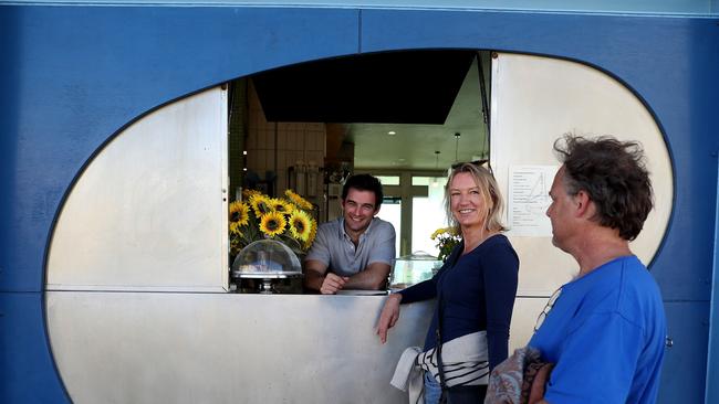 Chris King of Cottesloe Beach’s Mediterranean restaurant Barchetta serves customers Alex Giebeler and Sean Bell. Picture: Colin Murty