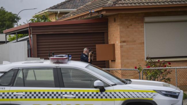 Police at the scene of the fatal house fire in Woodville Gardens. Picture: RoyVPhotography