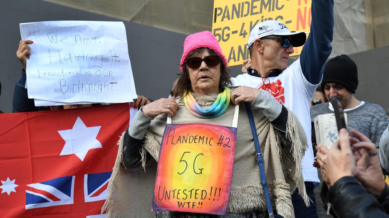 Protesters in Victoria hold placards against 5G and the coronavirus pandemic. Picture: William West/AFP