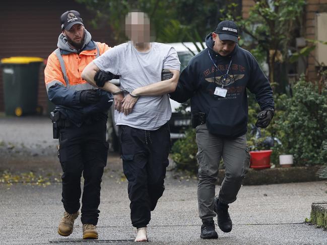 Constable John Trinnie and Senior Constable Asante Decena arrest a man over an AVO. Picture: Richard Dobson