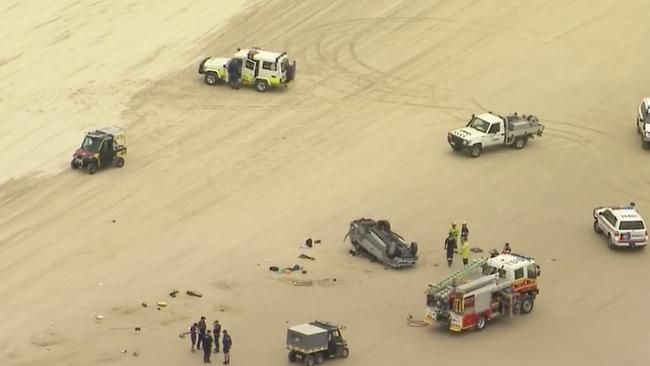 Emergency services surround the 4WD rollover at Teewah Beach on Sunday afternoon. Photo: Nine News