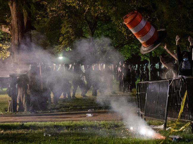 Police face off with demonstrators gathered outside the White House.