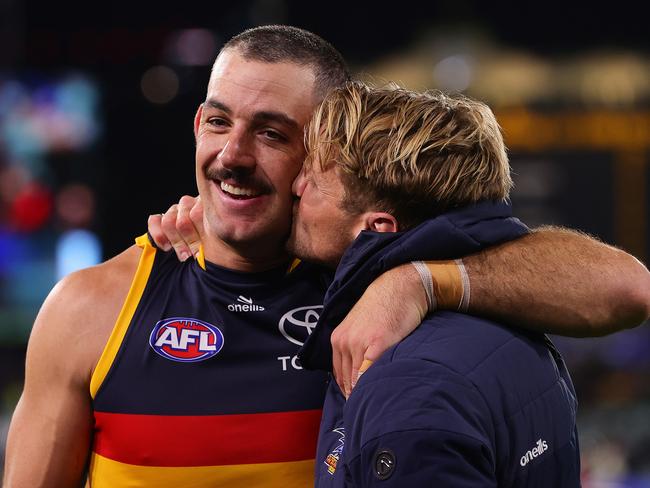 ADELAIDE, AUSTRALIA - MAY 02: Rory Sloane of the Crows plants a kiss on best mate Taylor Walker during the 2024 AFL Round 08 match between the Adelaide Crows and the Port Adelaide Power at Adelaide Oval on May 02, 2024 in Adelaide, Australia. (Photo by Sarah Reed/AFL Photos via Getty Images)