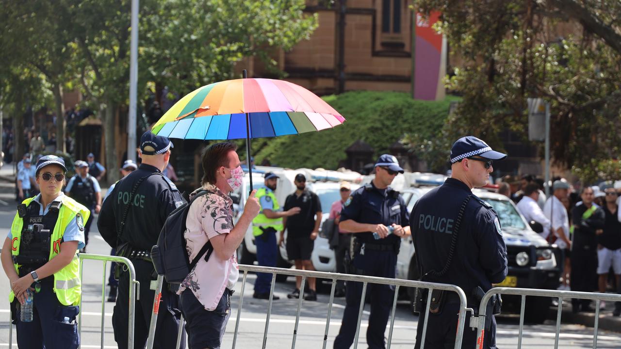 A man holding a rainbow umbrella was arrested. Picture: NCA NewsWire / Nicholas Eagar