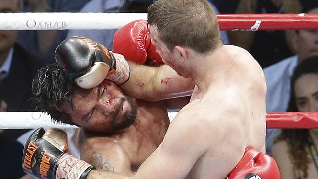 Manny Pacquiao of the Philippines, left, clinches with Jeff Horn of Australia,.  (AP Photo/Tertius Pickard)