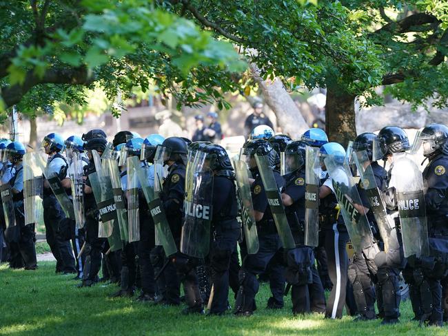 Police watch demonstrators protesting the death of George Floyd, near the White House. Picture: AFP