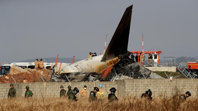 South Korean soldiers check near the wreckage of a passenger plane at Muan International Airport on December 29, 2024 in Muan-gun, South Korea. Picture: Chung Sung-Jun/Getty Images